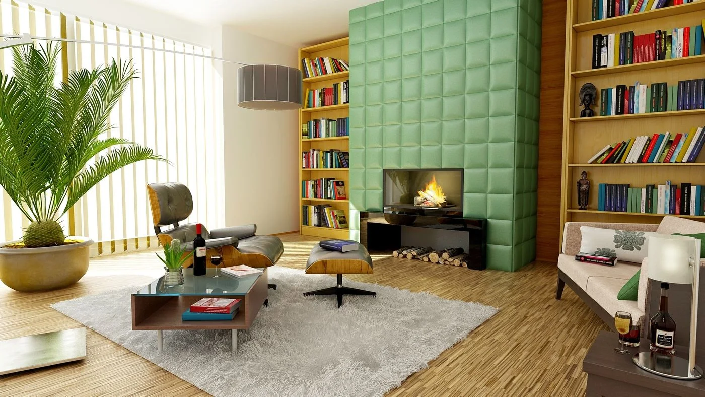 Living room with a green wall, books and upholstered seating