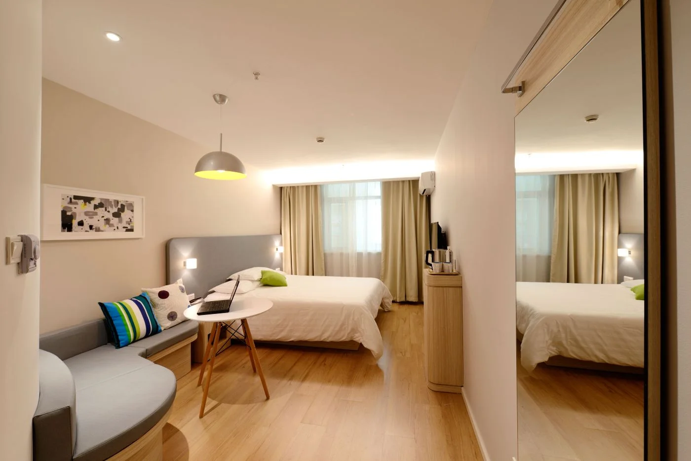 Bedroom with curtains beside a furnished sleeping area
